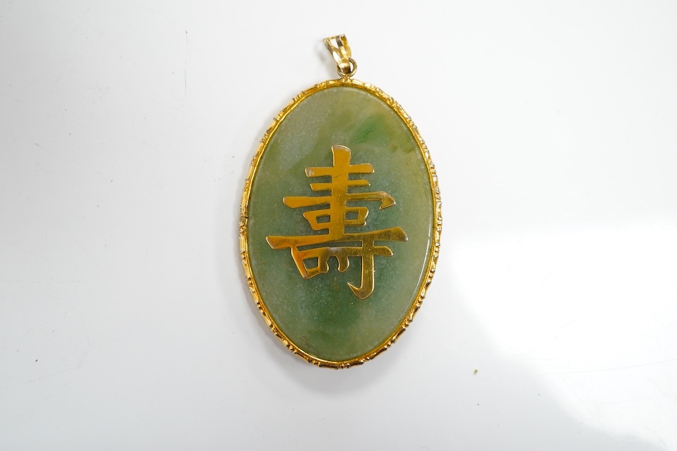 A gilt metal mounted Chinese hardstone pendant. Condition - fair to good